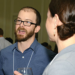 Chris Hakkenberg (environment and ecology), left, the Kevin Satisky and Judith Thorn Summer Research Fellow, speaks with Suzanne Buchta.