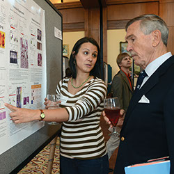 Jessica Sorrentino, left, explains her research to Don Buckley.