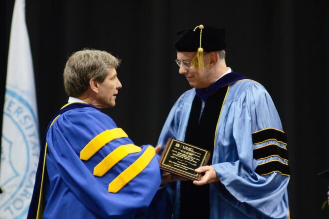 Vincas Steponaitis (right) receiving the Faculty Award for Excellence in Doctoral Mentoring from Graduate School Dean Steve Matson