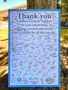 A poster containing many hand-written notes of thanks for the work of graduate students.