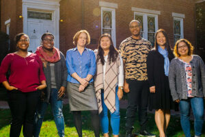 Members of the diversity and student success program pose on the lawn in front of a university building