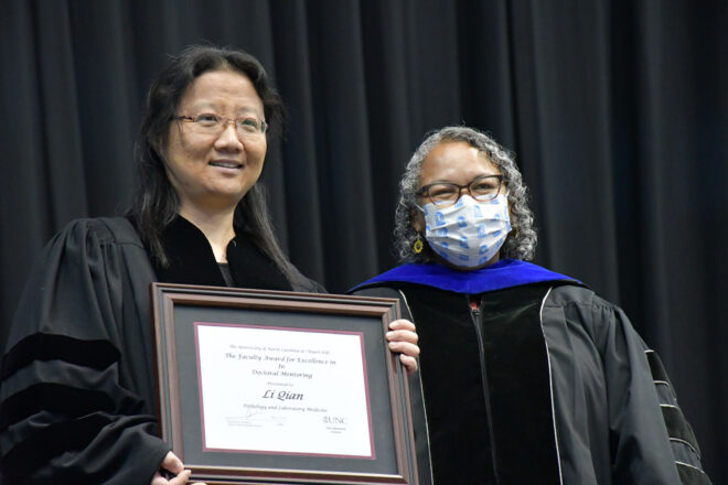 Suzanne Barbour and Li Qian. Li is holding a certificate